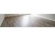 Wood-look flooring extends from wall to wall in this empty room at 11143 Aliyah Dr, Hampton, GA 30228