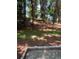 A wooded backyard with a partially constructed concrete patio area at 1808 Brewer Sw Blvd, Atlanta, GA 30310