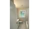 Clean bathroom featuring tile flooring, a modern vanity, and a window for natural light at 1808 Brewer Sw Blvd, Atlanta, GA 30310