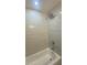 Bathroom featuring a shower with elegant tile work and modern fixtures, creating a spa-like experience at 1808 Brewer Sw Blvd, Atlanta, GA 30310