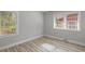 Bedroom with neutral walls, new windows, and wood laminate flooring at 1808 Brewer Sw Blvd, Atlanta, GA 30310