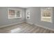 Bright bedroom featuring laminate floors and sunlit windows at 1808 Brewer Sw Blvd, Atlanta, GA 30310