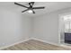 Bedroom with ceiling fan, wood-look floors, and access to the en-suite bathroom at 1808 Brewer Sw Blvd, Atlanta, GA 30310