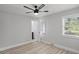 Bedroom with wood-look flooring, ceiling fan and a glimpse into the en-suite bathroom at 1808 Brewer Sw Blvd, Atlanta, GA 30310