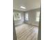 Serene bedroom with wood flooring, light gray walls, and multiple windows offering natural light at 1808 Brewer Sw Blvd, Atlanta, GA 30310