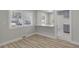 Bright dining area with wood floors, a breakfast bar, and a view of the modern kitchen at 1808 Brewer Sw Blvd, Atlanta, GA 30310