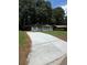 Traditional-style home with a large front yard, long driveway, and mature trees that create a serene setting at 1808 Brewer Sw Blvd, Atlanta, GA 30310