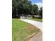 Inviting one story home with a long driveway and mature trees providing ample shade in the front yard at 1808 Brewer Sw Blvd, Atlanta, GA 30310