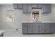Updated kitchen featuring blue cabinets, marble countertops, and a modern sink at 1808 Brewer Sw Blvd, Atlanta, GA 30310