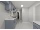 Spacious, updated kitchen featuring blue cabinets, white countertops, modern finishes, and marble tile flooring at 1808 Brewer Sw Blvd, Atlanta, GA 30310