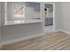 Kitchen area featuring modern gray cabinetry, sleek white countertops, and wood-look floors, blending style and functionality at 1808 Brewer Sw Blvd, Atlanta, GA 30310