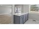 Modern kitchen with gray cabinets, quartz countertops, and open floorplan at 1808 Brewer Sw Blvd, Atlanta, GA 30310