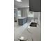 Bright kitchen featuring stainless steel sink, gray cabinets, and stunning marble countertops and flooring at 1808 Brewer Sw Blvd, Atlanta, GA 30310