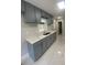 Modern kitchen featuring gray cabinets, marble countertops, and stainless steel sink at 1808 Brewer Sw Blvd, Atlanta, GA 30310