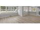 Sun-filled living area featuring updated wood-look floors, neutral walls, and multiple windows, creating a bright and airy feel at 1808 Brewer Sw Blvd, Atlanta, GA 30310