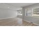 Bright living room featuring wood-look flooring, fresh paint, and windows providing plenty of natural light at 1808 Brewer Sw Blvd, Atlanta, GA 30310