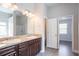 Bathroom with double sink vanity and granite countertops, featuring a view into an adjoining bedroom at 4950 Summersun Dr, Morrow, GA 30260