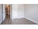 Neutral bedroom featuring modern gray flooring and hallway access to laundry area at 4950 Summersun Dr, Morrow, GA 30260