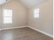 Neutral bedroom featuring modern gray flooring, bright white baseboards, and vaulted ceiling at 4950 Summersun Dr, Morrow, GA 30260