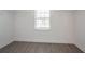Bright bedroom featuring modern gray flooring, window with blinds and built-in closet organizers at 4950 Summersun Dr, Morrow, GA 30260