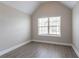 Neutral bedroom featuring modern gray flooring, bright white baseboards, and vaulted ceiling at 4950 Summersun Dr, Morrow, GA 30260