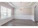 Elegant dining room with a tray ceiling, chandelier, and wainscoting at 4950 Summersun Dr, Morrow, GA 30260