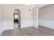 Dining room featuring hardwood floors, neutral walls, and archway to the kitchen at 4950 Summersun Dr, Morrow, GA 30260