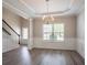 Spacious dining area with hardwood floors, staircase, and natural light at 4950 Summersun Dr, Morrow, GA 30260