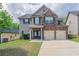 Charming two-story home with a brick facade and a two-car garage at 4950 Summersun Dr, Morrow, GA 30260