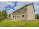Exterior view of tan siding with green lawn and blue sky with white clouds at 4950 Summersun Dr, Morrow, GA 30260