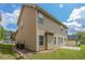 Exterior view of tan siding with green lawn and blue sky with white clouds at 4950 Summersun Dr, Morrow, GA 30260