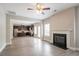 Open-concept living area with fireplace, hardwood floors, and seamless kitchen access at 4950 Summersun Dr, Morrow, GA 30260