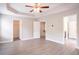 Large primary bedroom showcasing tray ceilings and multiple entryways to closets and bathrooms at 4950 Summersun Dr, Morrow, GA 30260