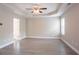 Bright primary bedroom with tray ceilings and a ceiling fan at 4950 Summersun Dr, Morrow, GA 30260