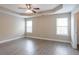 Spacious primary bedroom with tray ceilings, a ceiling fan, and natural light from two windows at 4950 Summersun Dr, Morrow, GA 30260