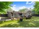 Inviting backyard with outdoor seating, wood deck, artificial turf and pergola, ideal for enjoying outdoor living at 541 Benmac Se Rd, Smyrna, GA 30080