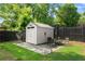 Cozy backyard featuring a storage shed and outdoor seating area, perfect for relaxing or entertaining guests at 541 Benmac Se Rd, Smyrna, GA 30080