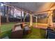 Inviting backyard features a covered seating area, manicured lawn, and privacy fence at 541 Benmac Se Rd, Smyrna, GA 30080