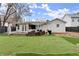 An inviting backyard featuring a covered deck, outdoor seating, and a well-maintained lawn offers a relaxing space at 541 Benmac Se Rd, Smyrna, GA 30080