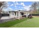 Outdoor space featuring a pergola, deck, fenced yard, and artificial grass at 541 Benmac Se Rd, Smyrna, GA 30080