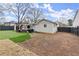 Large backyard featuring artificial grass, a pergola, and ample space for outdoor activities at 541 Benmac Se Rd, Smyrna, GA 30080