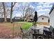 Backyard sitting area with shade umbrella and landscaping at 541 Benmac Se Rd, Smyrna, GA 30080