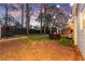 Large backyard featuring both brick and turf sections. Includes a dining area, grill, and a black perimeter fence at 541 Benmac Se Rd, Smyrna, GA 30080