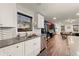 Well-lit kitchen with stainless steel appliances, tile backsplash, and an open view to the living area at 541 Benmac Se Rd, Smyrna, GA 30080