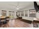 Sunroom with wood floors, many windows, ceiling fan, desk and a backyard view at 541 Benmac Se Rd, Smyrna, GA 30080