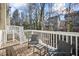 Outdoor deck with patio furniture, providing a relaxing space with views of the surrounding trees and neighborhood at 8540 Hope Mews Ct, Atlanta, GA 30350