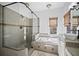 Inviting bathroom features soaking tub, walk-in shower, and granite countertops at 8540 Hope Mews Ct, Atlanta, GA 30350
