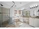 Gorgeous bathroom featuring a tub, glass shower, and double vanity at 8540 Hope Mews Ct, Atlanta, GA 30350