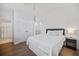 Comfortable bedroom featuring hardwood floors, closet and ensuite bathroom at 8540 Hope Mews Ct, Atlanta, GA 30350