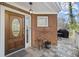 Inviting front porch with brick accent, decorative door, and tiled flooring at 8540 Hope Mews Ct, Atlanta, GA 30350